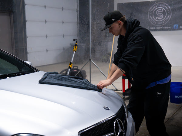 Exterior car detailing in Regina drying and cleaning vehicle paint